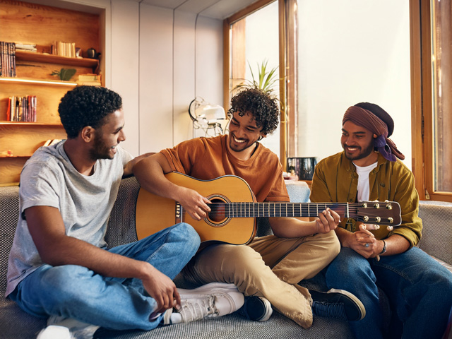 Friends playing guitar together
